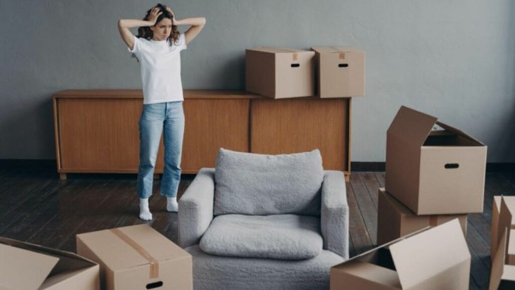 stressed woman surrounded by boxes